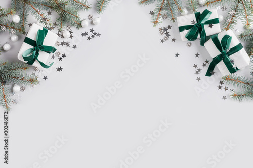 Christmas frame with white gifts on grey. Merry christmas card. Winter holiday. Happy New Year. Space for text