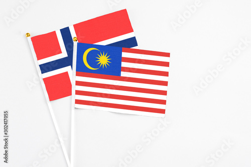 Malaysia and Bouvet Islands stick flags on white background. High quality fabric, miniature national flag. Peaceful global concept.White floor for copy space.