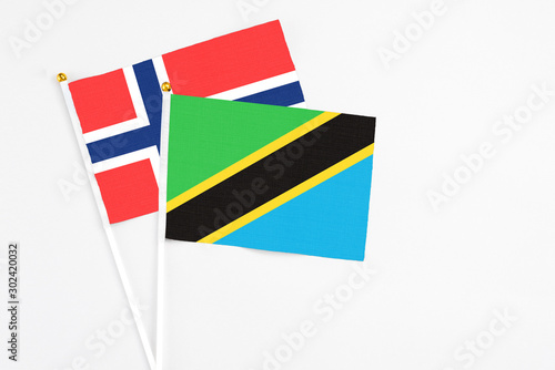 Tanzania and Bouvet Islands stick flags on white background. High quality fabric, miniature national flag. Peaceful global concept.White floor for copy space. photo