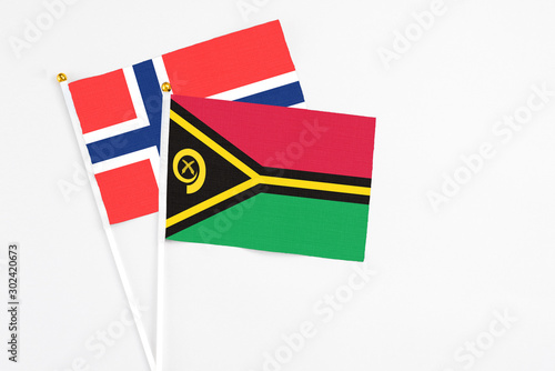 Vanuatu and Bouvet Islands stick flags on white background. High quality fabric, miniature national flag. Peaceful global concept.White floor for copy space. photo