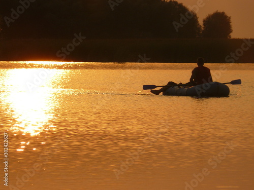 two in a boat at sunset