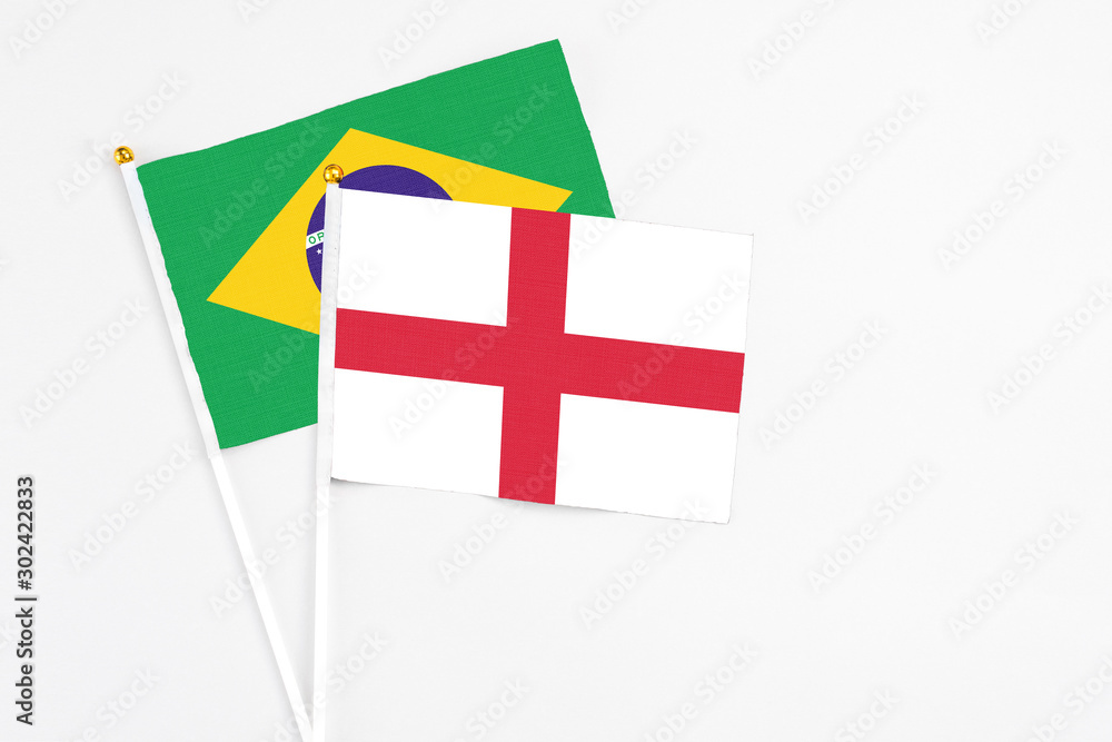England and Brazil stick flags on white background. High quality fabric, miniature national flag. Peaceful global concept.White floor for copy space.