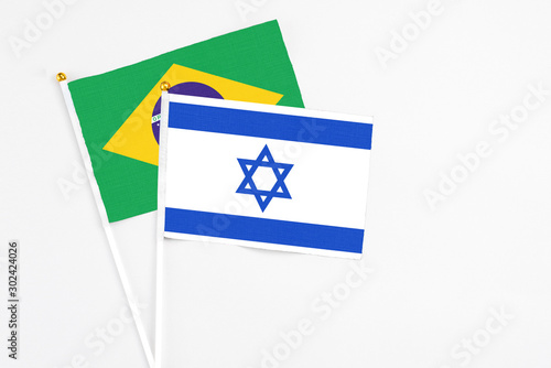 Free Download Israel and Brazil stick flags on white background. High quality fabric, miniature national flag. Peaceful global concept.White floor for copy space. - GFXLoad