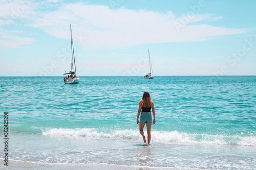 Girl Walking Into the Waves