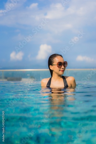 Portrait beautiful young asian women happy smile relax outdoor swimming pool in resort © siraphol