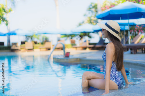 Portrait beautiful young asian women happy smile relax outdoor swimming pool in resort