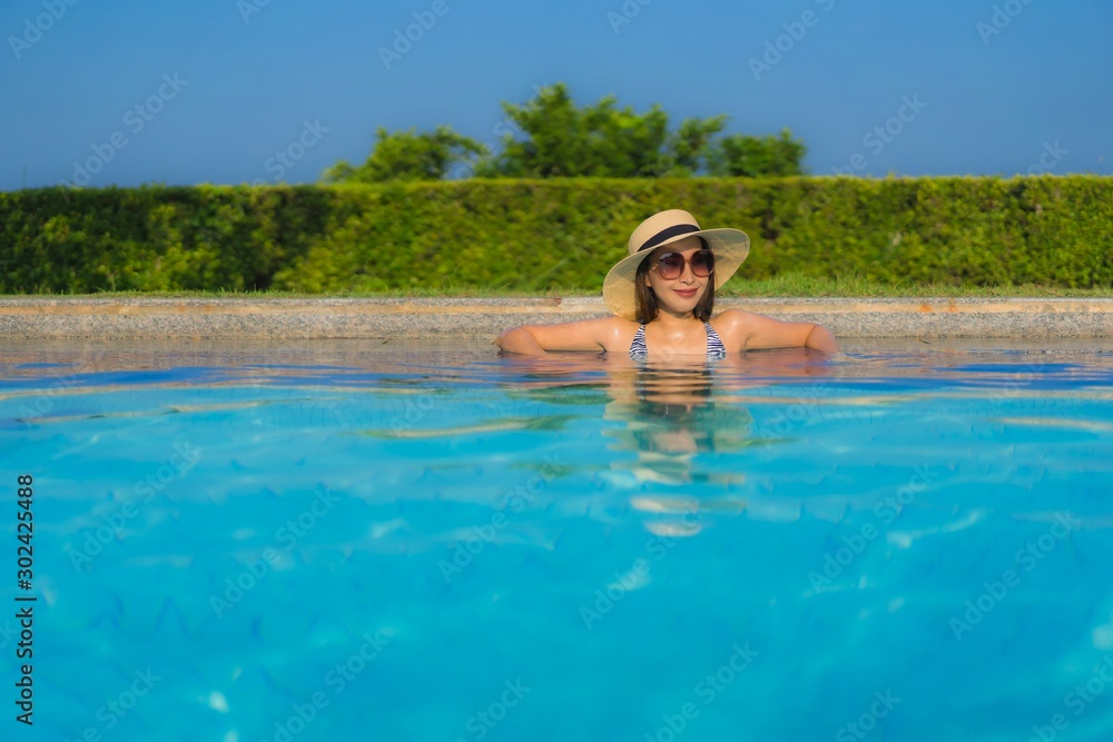 Portrait beautiful young asian women happy smile relax outdoor swimming pool in resort