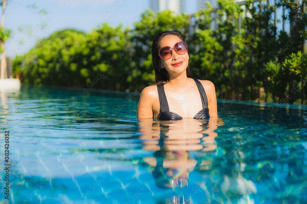 Portrait beautiful young asian women happy smile relax outdoor swimming pool in resort