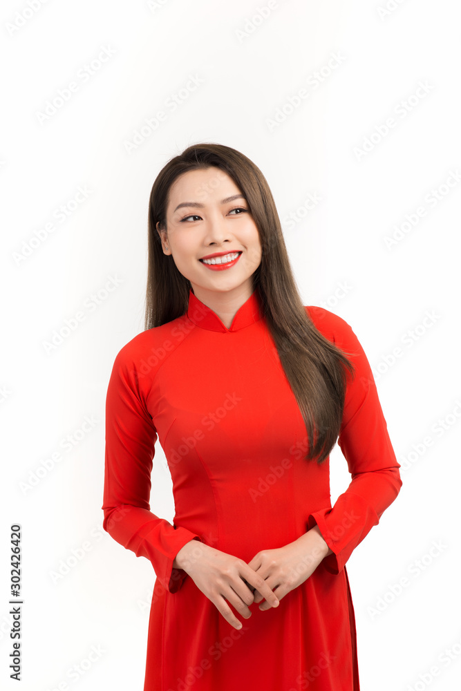 Close up portrait of beautiful asian girl dressed in traditional Ao Dai red dress stands over white background Close up portrait of beautiful asian girl dressed in traditional Ao Dai red dress stands over white background