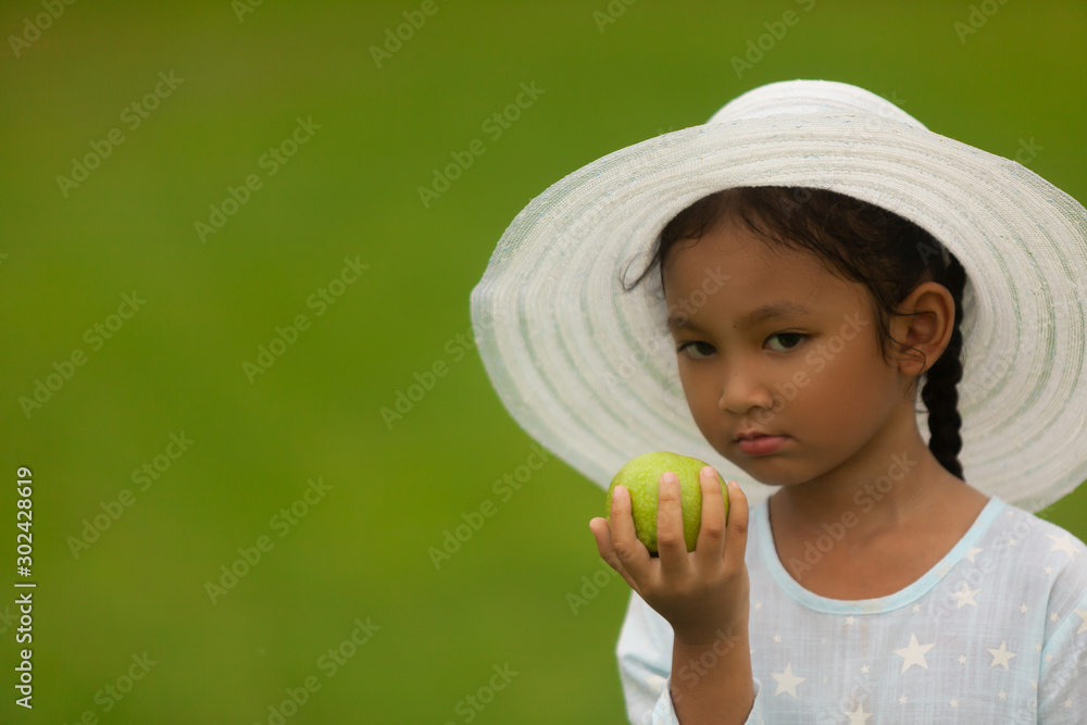beautiful children in a hat eating an apple on nature beautiful children in a hat eating an apple on nature