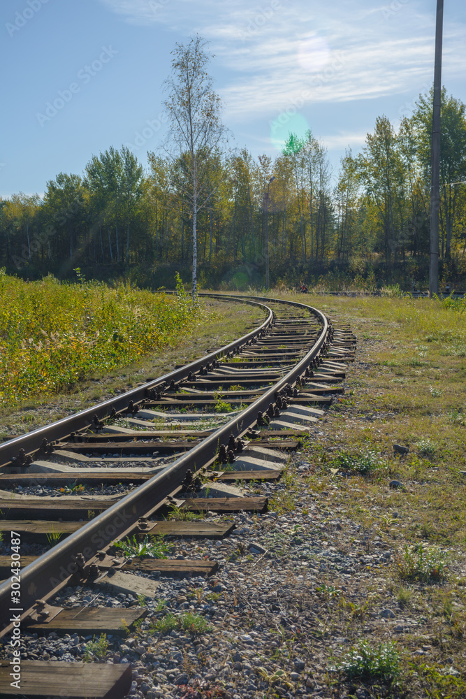 Rail transport infrastructure in Europe. Train tracks that turn left. Railroad and means of transport concept Rail transport infrastructure in Europe. Train tracks that turn left. Railroad and means of transport concept