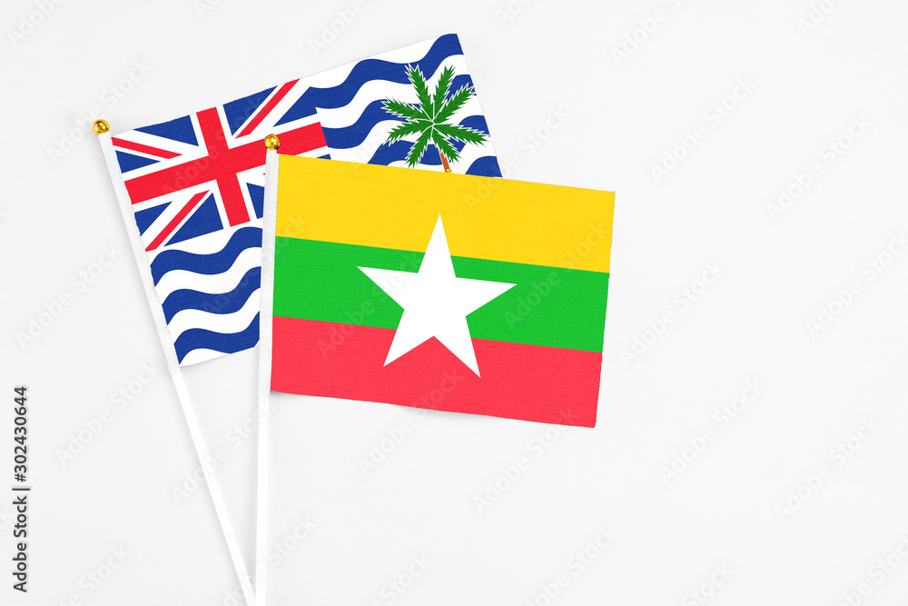 Fototapeta premium Myanmar and British Indian Ocean Territory stick flags on white background. High quality fabric, miniature national flag. Peaceful global concept.White floor for copy space.