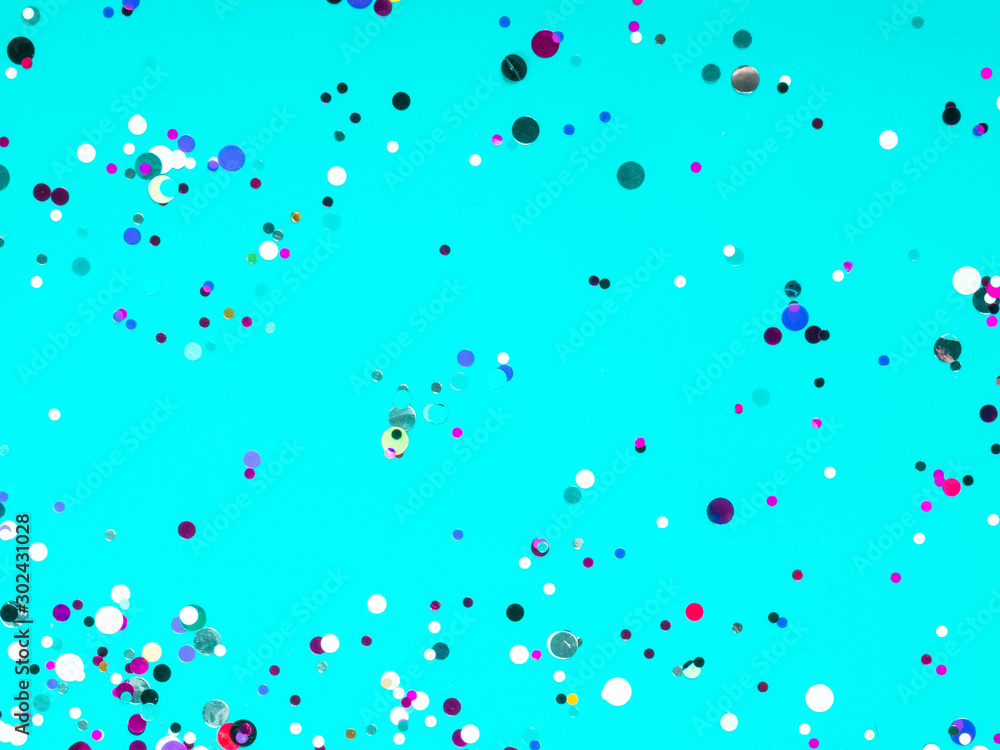 Colorful sparkles confetti on blue holiday background. Festive backdrop for your projects, postcard Colorful sparkles confetti on blue holiday background. Festive backdrop for your projects, postcard