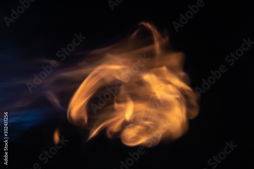 Throw soft blur flame with blue flame from the left side on black background. For overlay effect