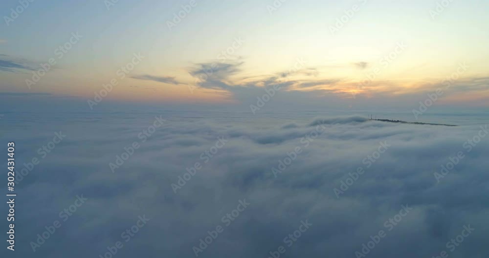 The sun is hidden behind the clouds at sunset fog. Drone flying over the clouds at sunset. The sun is hidden behind the clouds at sunset fog. Drone flying over the clouds at sunset.