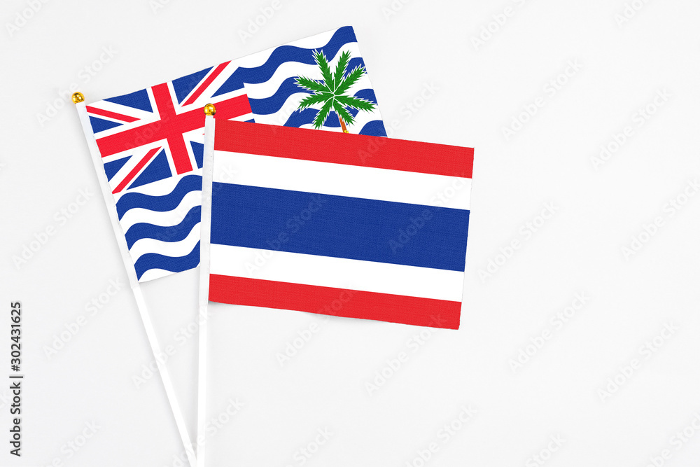 Thailand and British Indian Ocean Territory stick flags on white background. High quality fabric, miniature national flag. Peaceful global concept.White floor for copy space. Thailand and British Indian Ocean Territory stick flags on white background. High quality fabric, miniature national flag. Peaceful global concept.White floor for copy space.