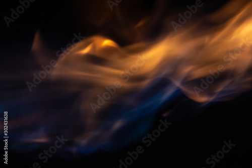 Soft blur flame with soft detail moving around with some blue flame on black background. For overlay effect