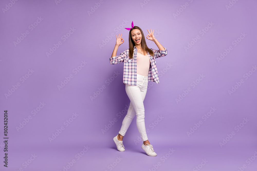 Full length photo of positive cheerful girl go walk show okay sign choose decide advise ads promo wear pin-up pinup clothing sneakers isolated purple color background