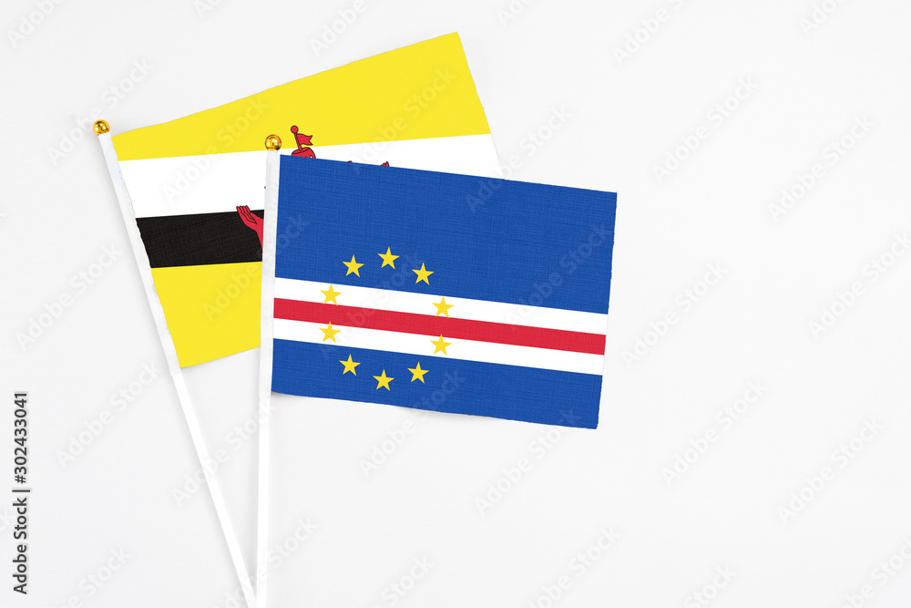 Cape Verde and Brunei stick flags on white background. High quality fabric, miniature national flag. Peaceful global concept.White floor for copy space. Cape Verde and Brunei stick flags on white background. High quality fabric, miniature national flag. Peaceful global concept.White floor for copy space.