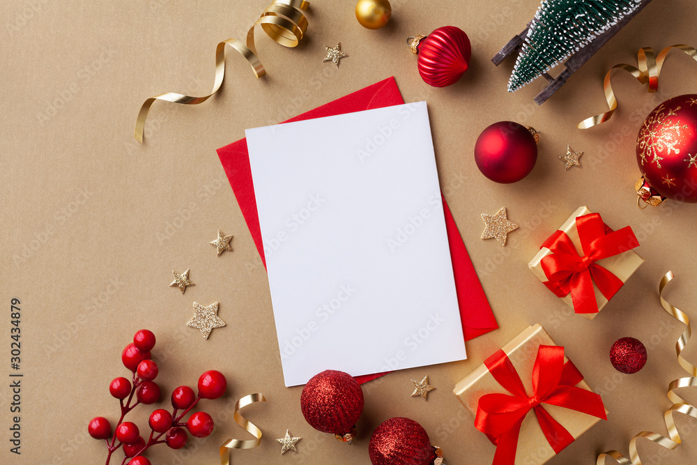 Empty paper blank for Christmas or New year greeting card. Gift boxes,  holiday decorations, small fir tree on golden background top view. Flat  lay. Stock Photo | Adobe Stock