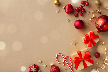 Christmas composition. Gift boxes, holiday decorations on golden background top view. Flat lay.