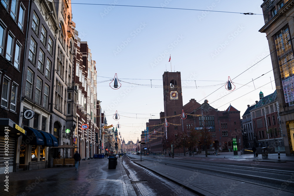 Amsterdam, Netherlands - Empty early morning street of Amsterdam city, decorated for the Christmas holiday Amsterdam, Netherlands - Empty early morning street of Amsterdam city, decorated for the Christmas holiday