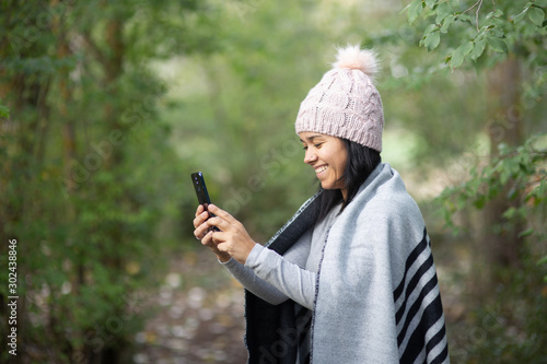 Woman using mobile in nature