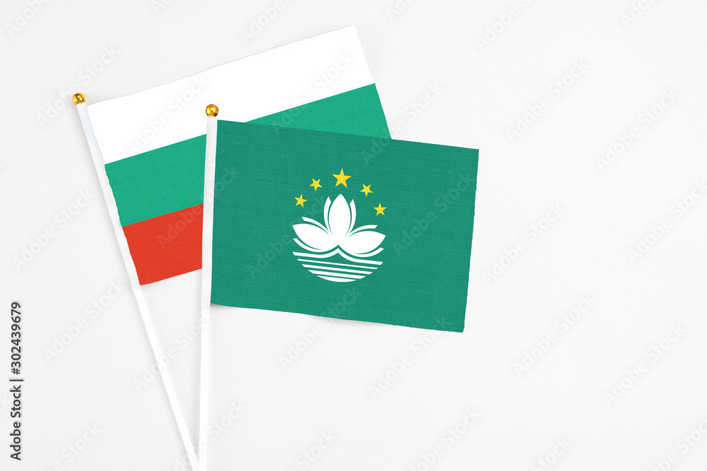 Macao and Bulgaria stick flags on white background. High quality fabric, miniature national flag. Peaceful global concept.White floor for copy space.