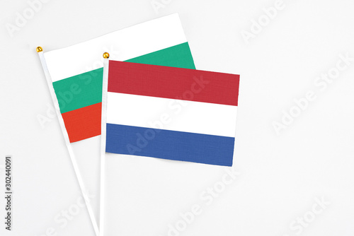 Netherlands and Bulgaria stick flags on white background. High quality fabric, miniature national flag. Peaceful global concept.White floor for copy space. Free Download Netherlands and Bulgaria stick flags on white background. High quality fabric, miniature national flag. Peaceful global concept.White floor for copy space. - GFXLoad
