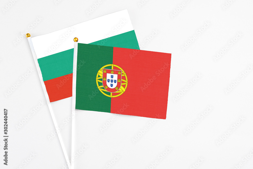 Portugal and Bulgaria stick flags on white background. High quality fabric, miniature national flag. Peaceful global concept.White floor for copy space. Portugal and Bulgaria stick flags on white background. High quality fabric, miniature national flag. Peaceful global concept.White floor for copy space.