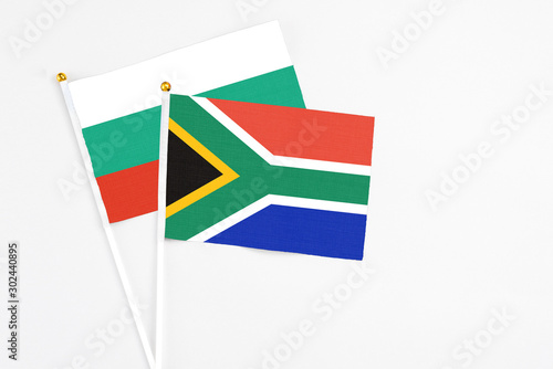South Africa and Bulgaria stick flags on white background. High quality fabric  miniature national flag. Peaceful global concept.White floor for copy space.