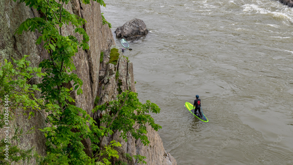 Man on Kayak in wetsuit on kayak on the river Man on Kayak in wetsuit on kayak on the river
