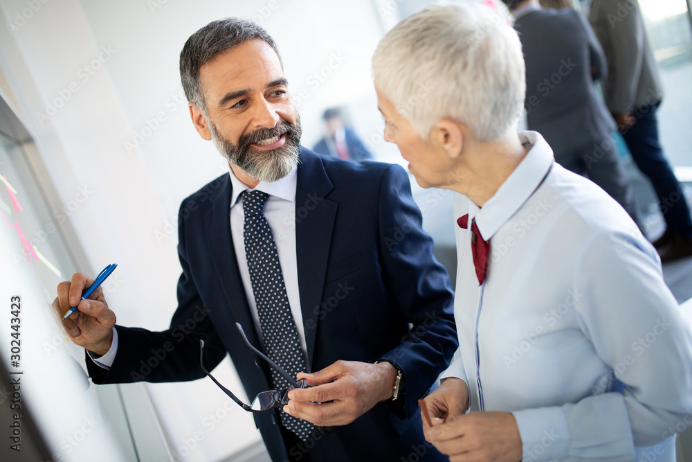 Portrait of happy business people discussing together in office Portrait of happy business people discussing together in office