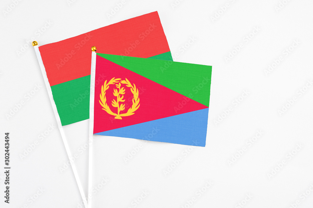 Eritrea and Burkina Faso stick flags on white background. High quality fabric, miniature national flag. Peaceful global concept.White floor for copy space. Eritrea and Burkina Faso stick flags on white background. High quality fabric, miniature national flag. Peaceful global concept.White floor for copy space.
