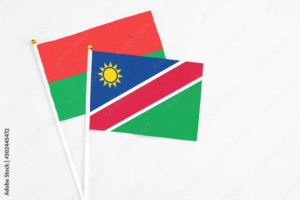 Namibia and Burkina Faso stick flags on white background. High quality fabric, miniature national flag. Peaceful global concept.White floor for copy space. Namibia and Burkina Faso stick flags on white background. High quality fabric, miniature national flag. Peaceful global concept.White floor for copy space.