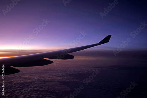 Plane, aeroplane wing, clouds, gradient sky from aerial view