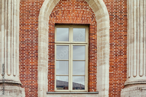Antique window on a brick wall of a castle, closeup