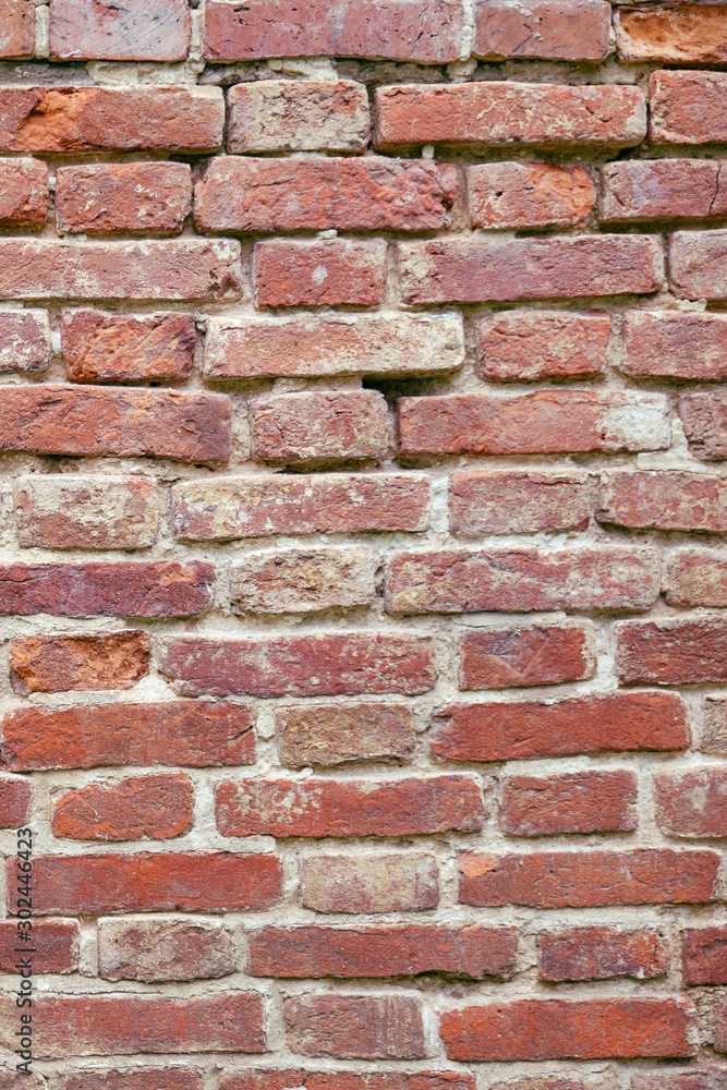 Texture of ancient brickwork, red cracked brick wall Texture of ancient brickwork, red cracked brick wall