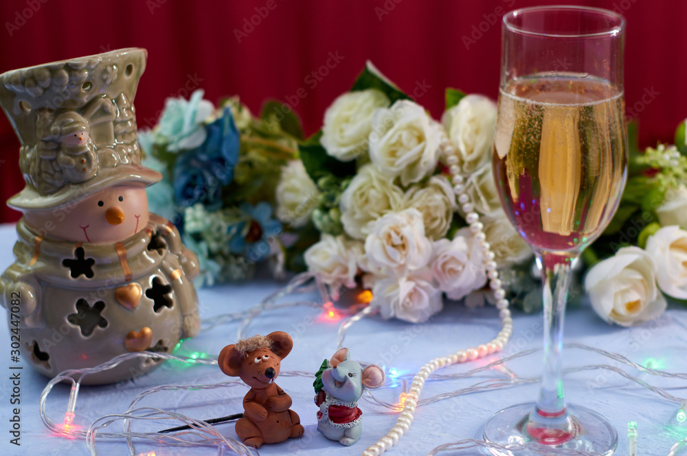 Happy New Year. Christmas. Year of the rat 2020 glass of champagne with two toy mice Christmas background close-up.