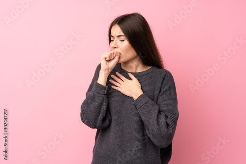 Quadro su tela Young woman over isolated pink background is suffering with cough and feeling ba
