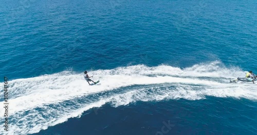 Wallpaper Mural Drone tracking shot Over Man Riding A Jet Ski At Tropical Paradise Exotic Island with blue and turquoise ocean sea view. Adventure Concept for Tourist Attraction at Beach Vacation sport at Summer day Torontodigital.ca