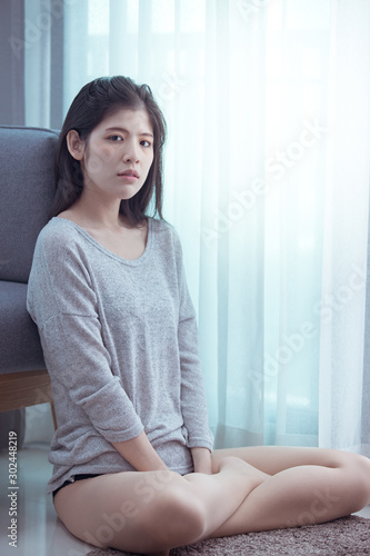 Beautiful woman lying on the sofa with the light by the window