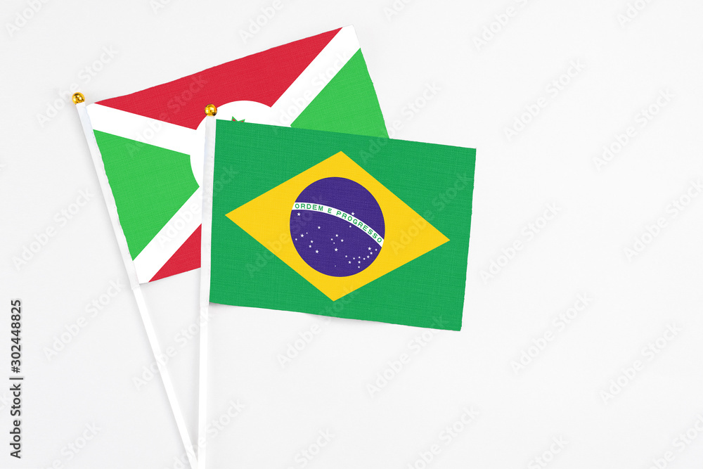 Brazil and Burundi stick flags on white background. High quality fabric, miniature national flag. Peaceful global concept.White floor for copy space.