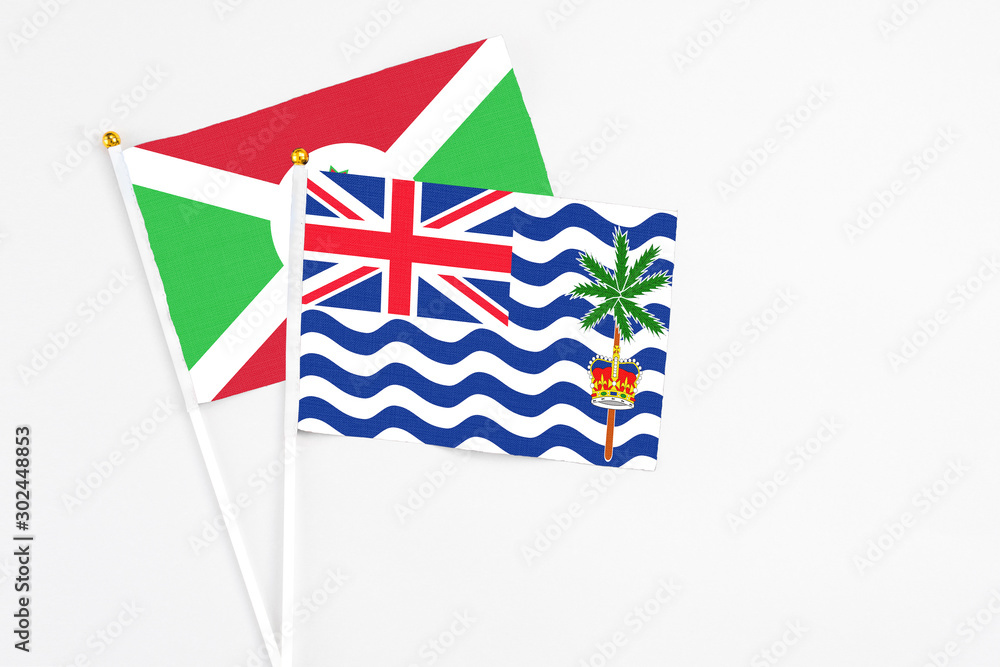 Fototapeta premium British Indian Ocean Territory and Burundi stick flags on white background. High quality fabric, miniature national flag. Peaceful global concept.White floor for copy space.