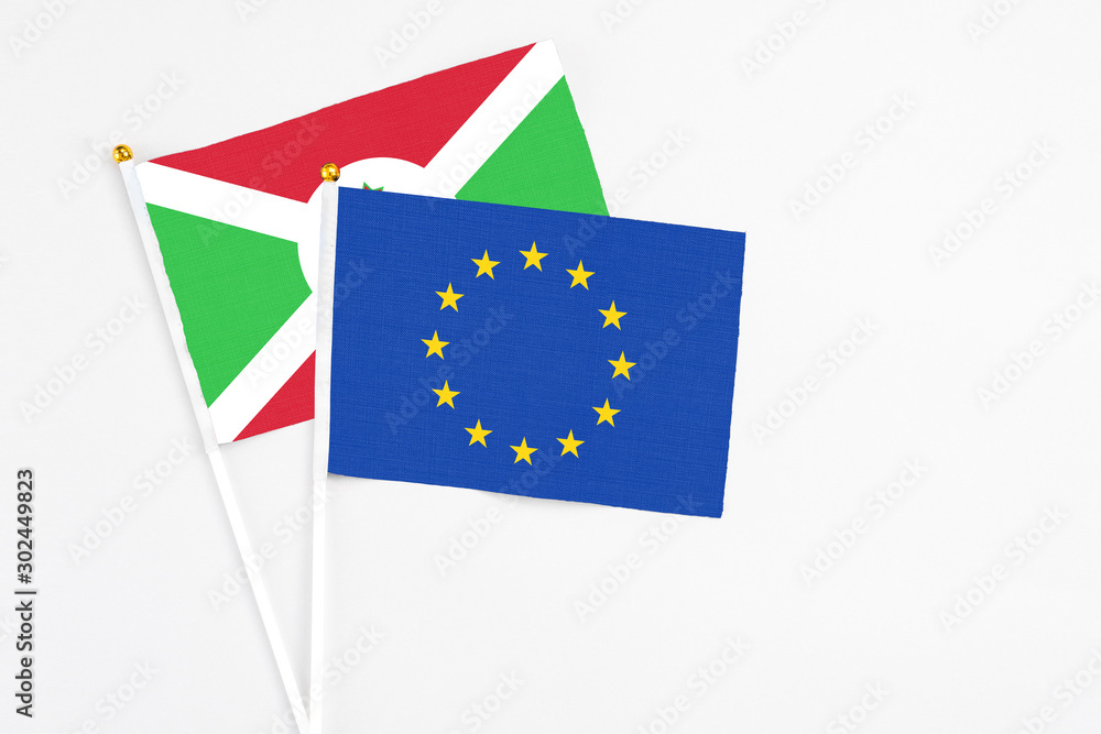 European Union and Burundi stick flags on white background. High quality fabric, miniature national flag. Peaceful global concept.White floor for copy space. European Union and Burundi stick flags on white background. High quality fabric, miniature national flag. Peaceful global concept.White floor for copy space.