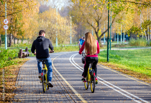 Cyclists ride on the bike path in the city Park