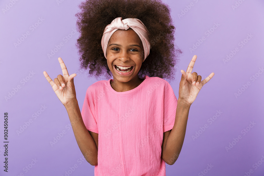 Young african girl kid showing rock gesture. Young african girl kid showing rock gesture.