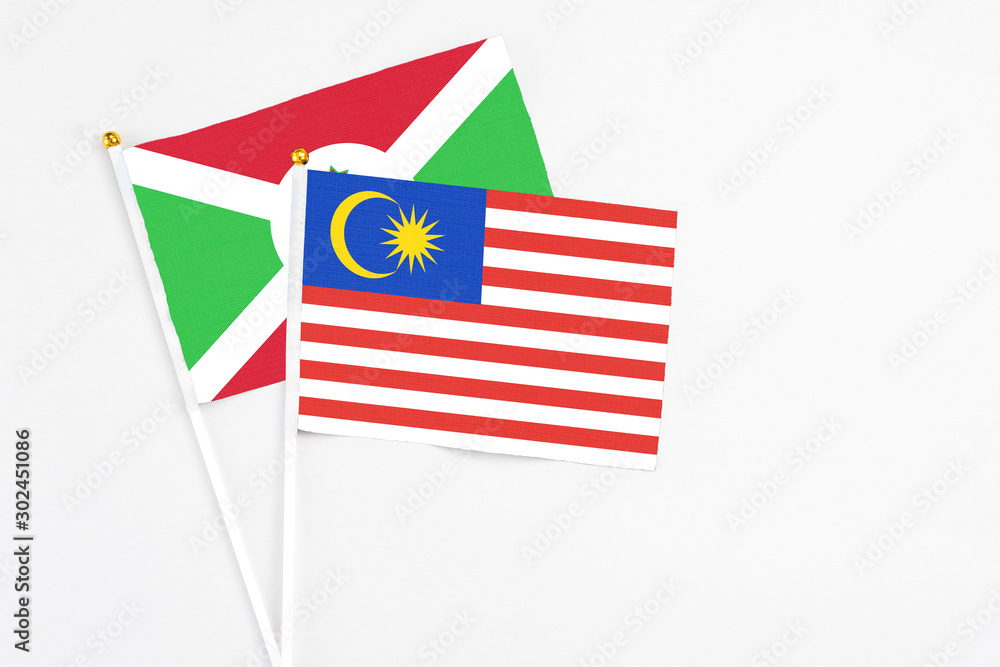 Malaysia and Burundi stick flags on white background. High quality fabric, miniature national flag. Peaceful global concept.White floor for copy space. Malaysia and Burundi stick flags on white background. High quality fabric, miniature national flag. Peaceful global concept.White floor for copy space.