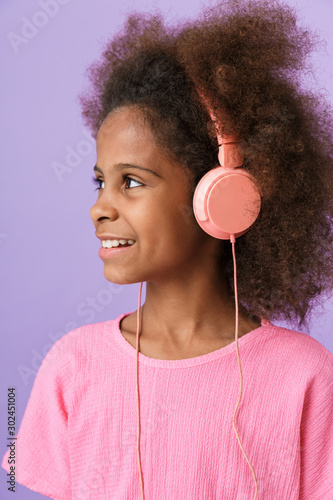 Happy young african girl kid with headphones.