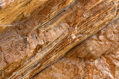 Brown red mountains shale steep cliffs near the trail, mountain trail along steep cliffs in Spain, Ardales the caminito caminito del rey. Tall red rocks mountain side in el Chorro